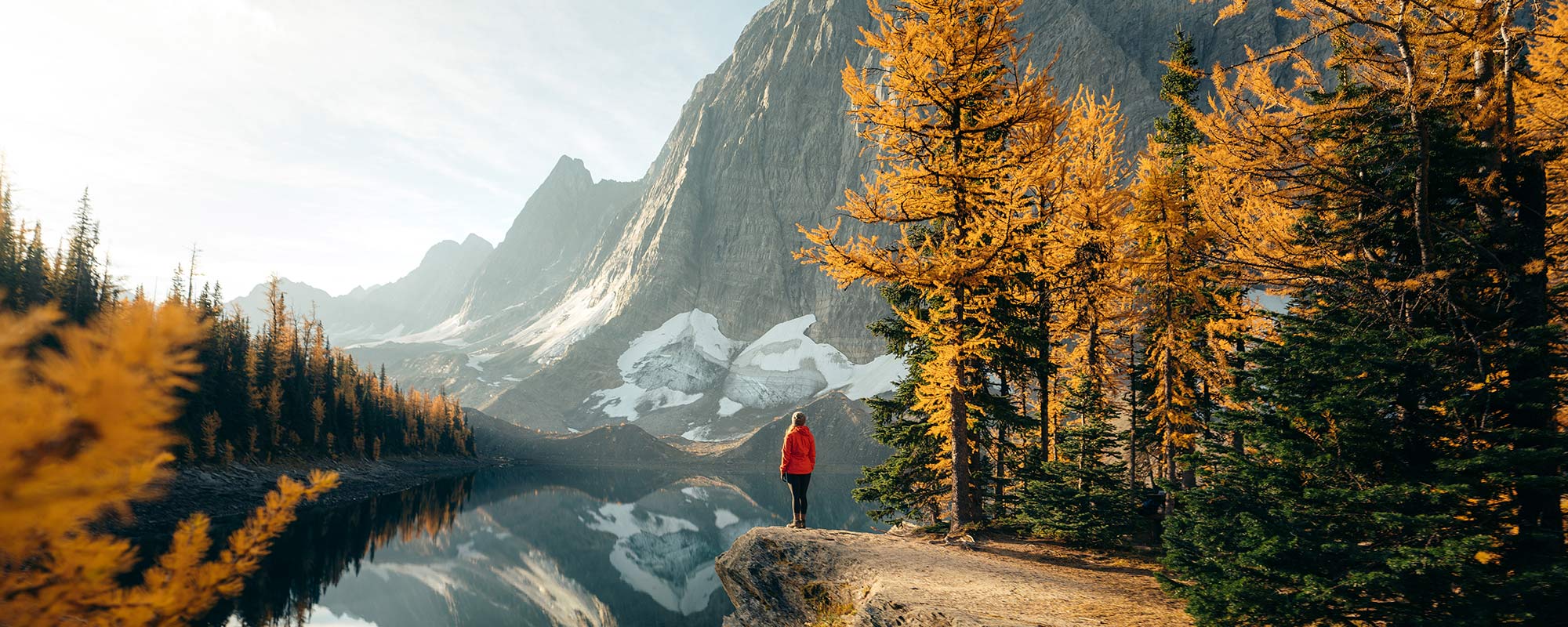 standing on the edge overlooking the water and mountains